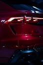Sleek Red Car Tail Lights at Night
