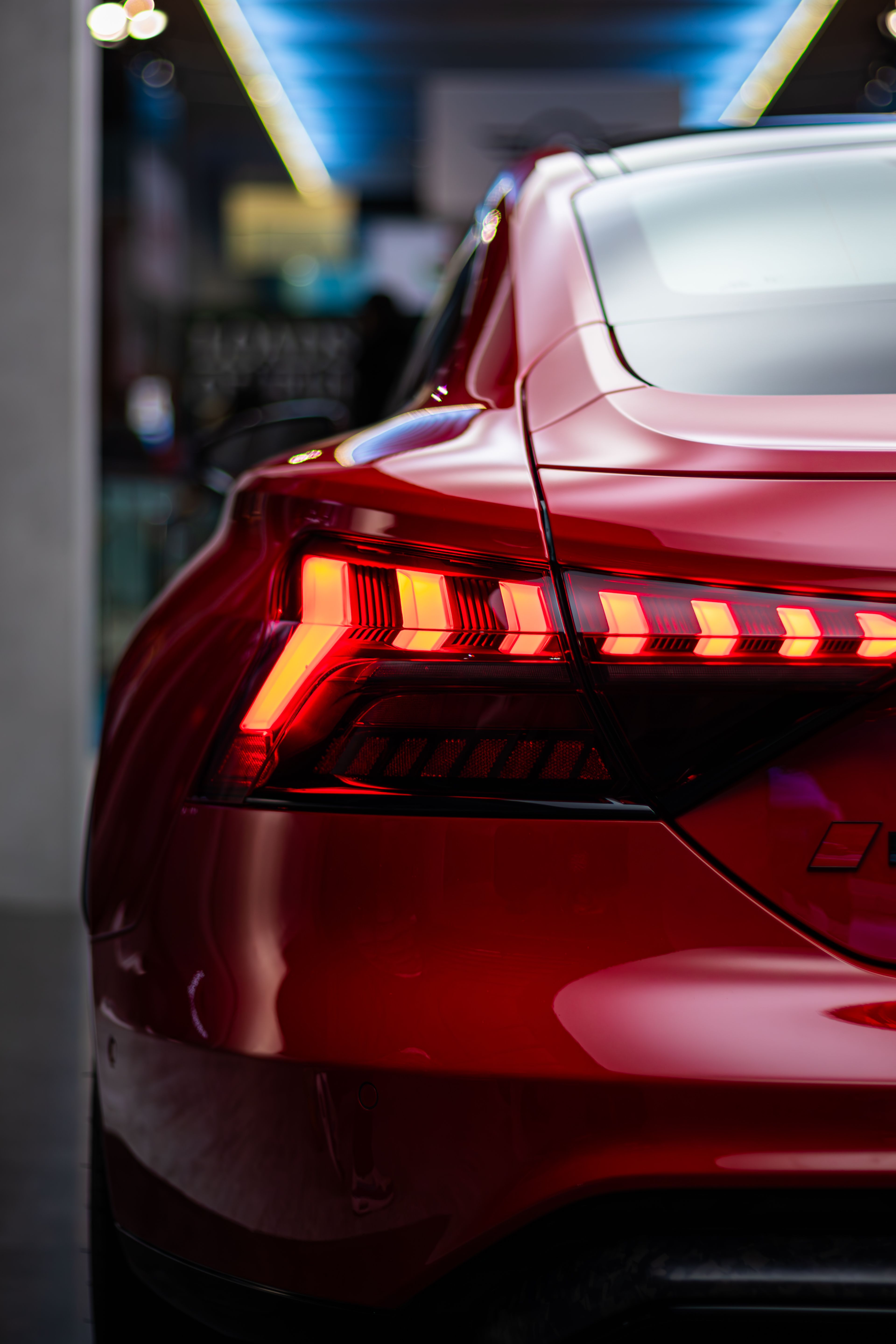 Sleek Red Car Tail Light at Toronto Auto Show · Free Stock Photo
