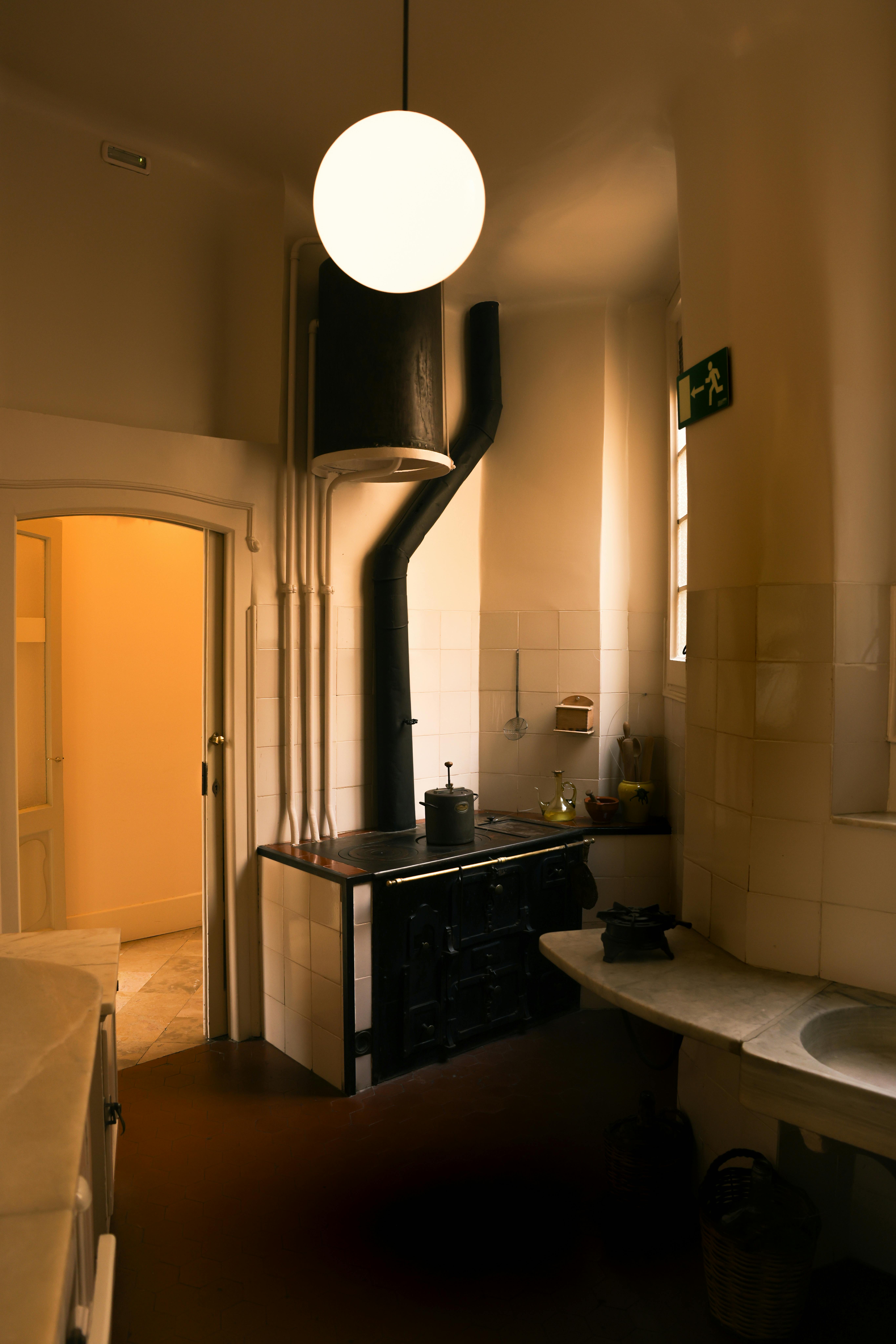 Warm vintage kitchen interior in Barcelona with rustic features and soft lighting.