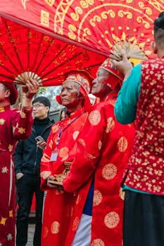 Elderly men in vibrant traditional attire at an Asian cultural festival.