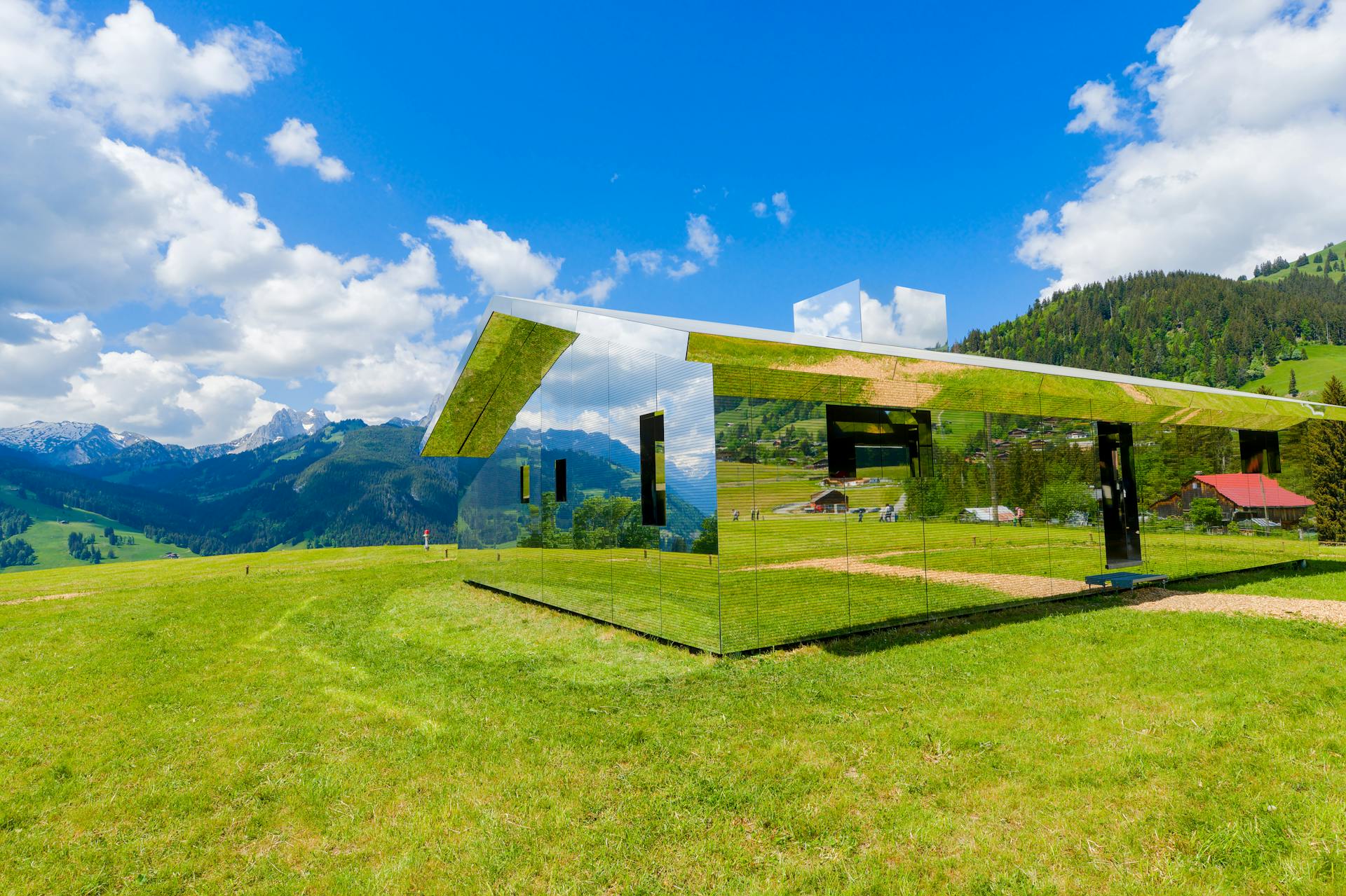 Unique mirrored building reflecting Swiss Alps scenery in Saanen.