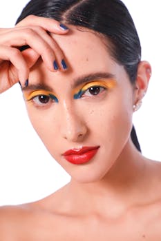 Close-up portrait featuring colorful eye makeup and vivid lips, showcasing elegance and glamour.
