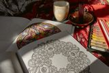 Coloring book page with pencils and tea — photo by Yeşim Çolak on Pexels
