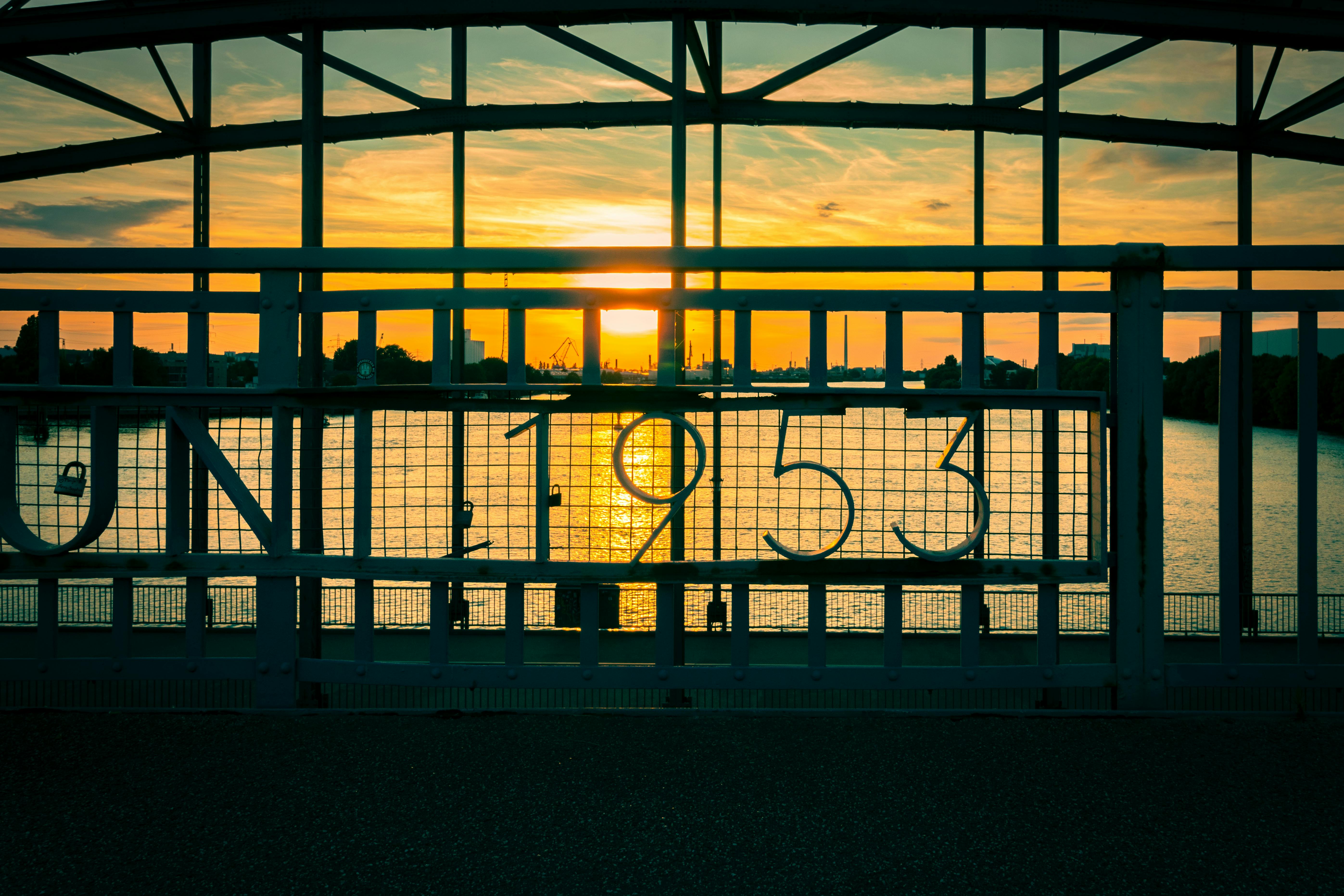 Captivating sunset view through a historic bridge in Hamburg, highlighting the year 1953.