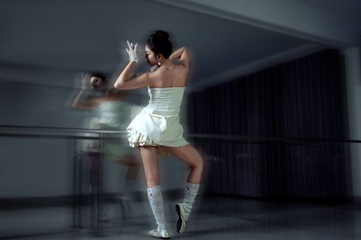 Contemporary dancer striking an elegant pose in a modern studio setting, showcasing artistic expression.