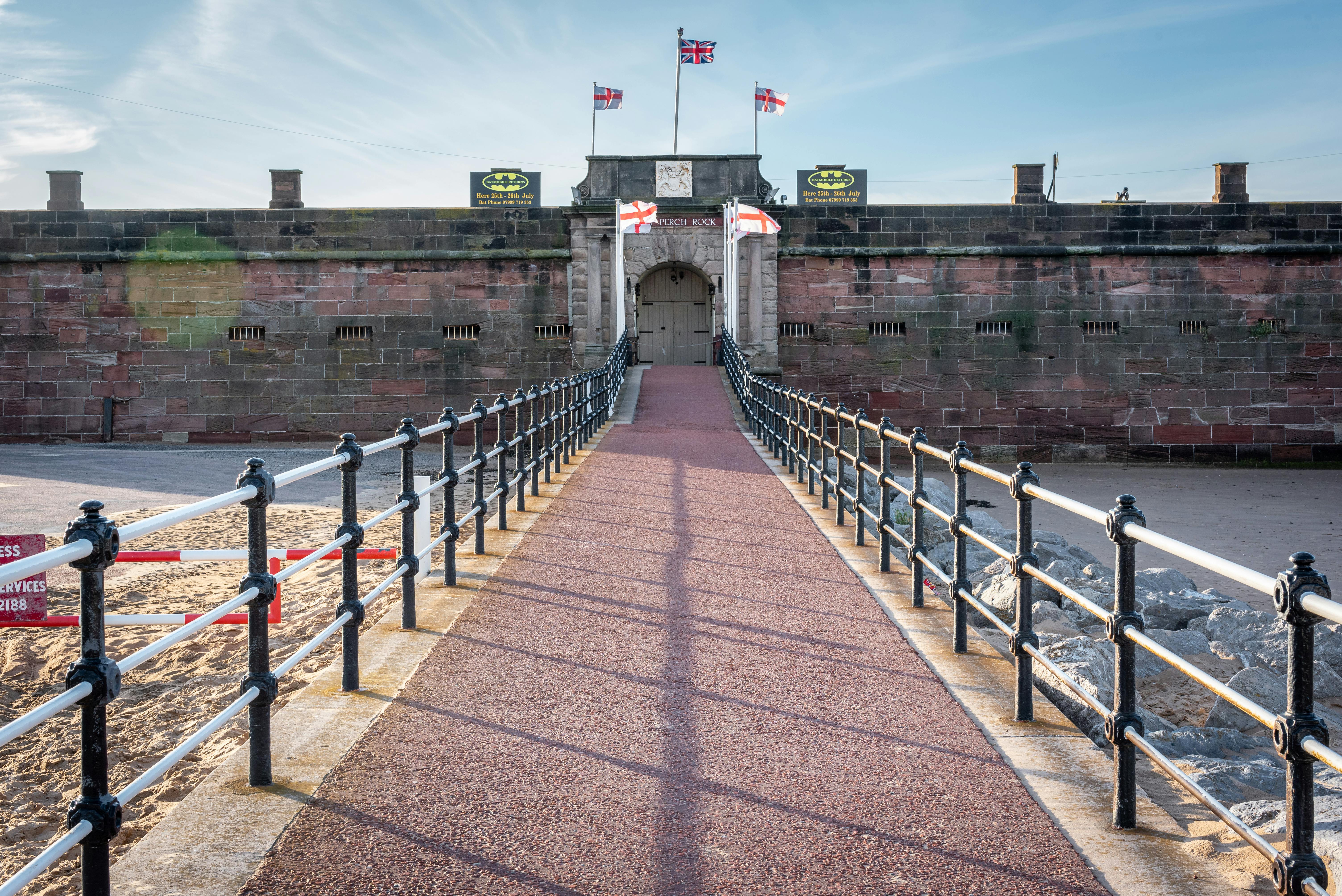 Fort Perch Rock in New Brighton, UK, with flags on a sunny day.