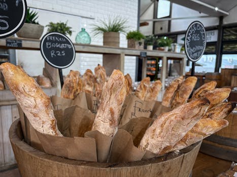 A display of freshly baked French baguettes in a rustic artisan bakery setting.