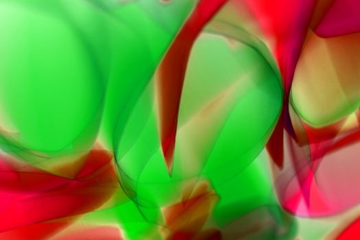 Colorful abstract art featuring dynamic wavy patterns in vivid red and green tones.