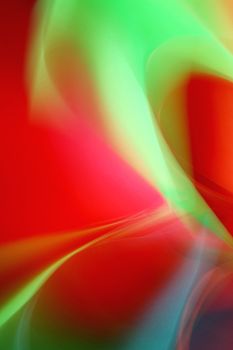 Dynamic abstract artwork featuring vivid red, green, and yellow light swirls.