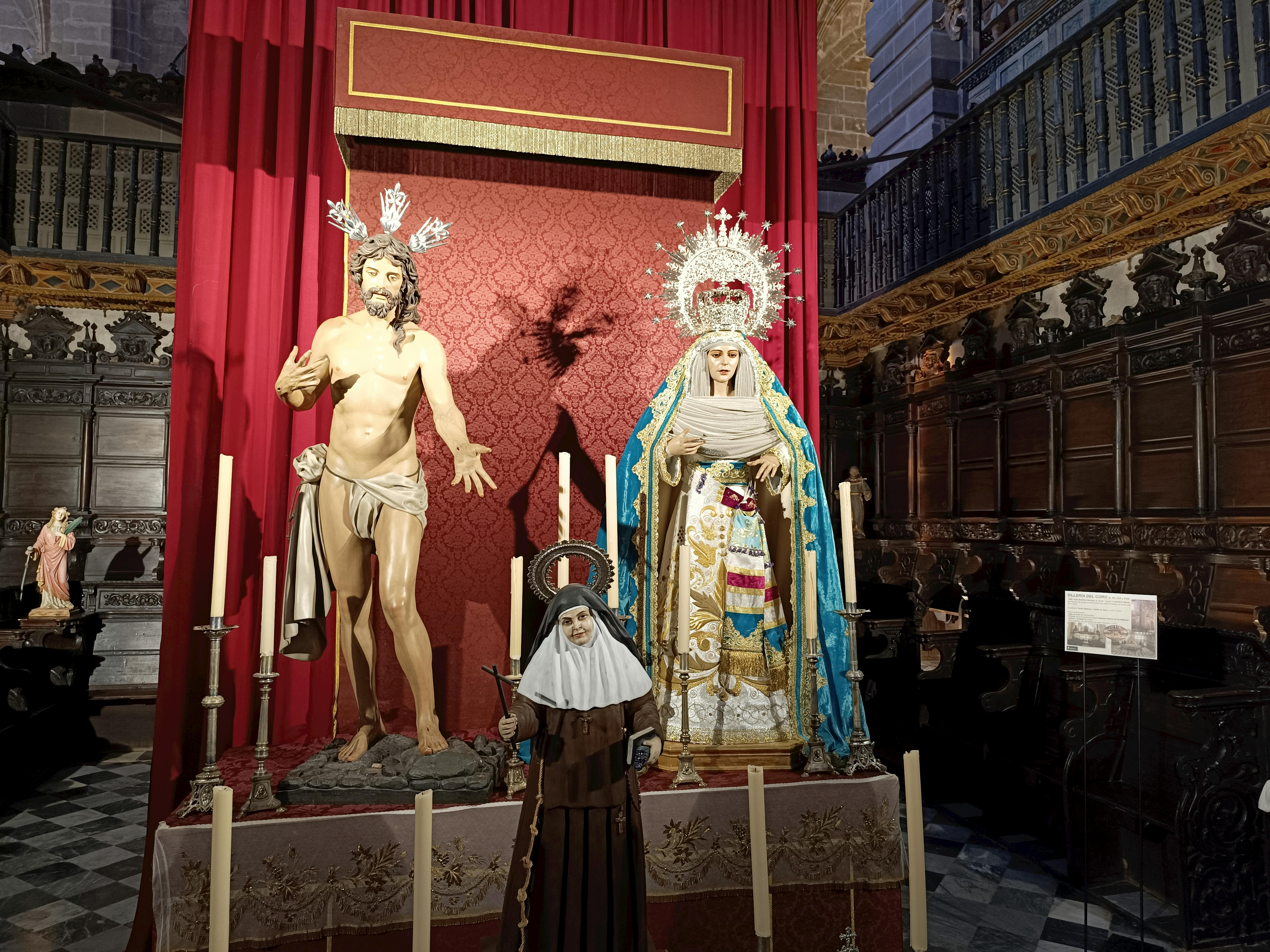 Intricate religious statues displayed in a historic Spanish church interior.