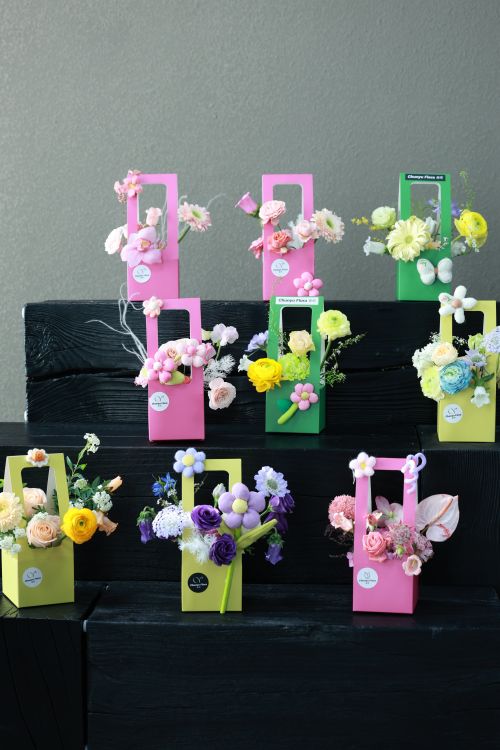 Free A stunning display of flowers in pastel-themed gift boxes. Perfect for celebrations. Stock Photo