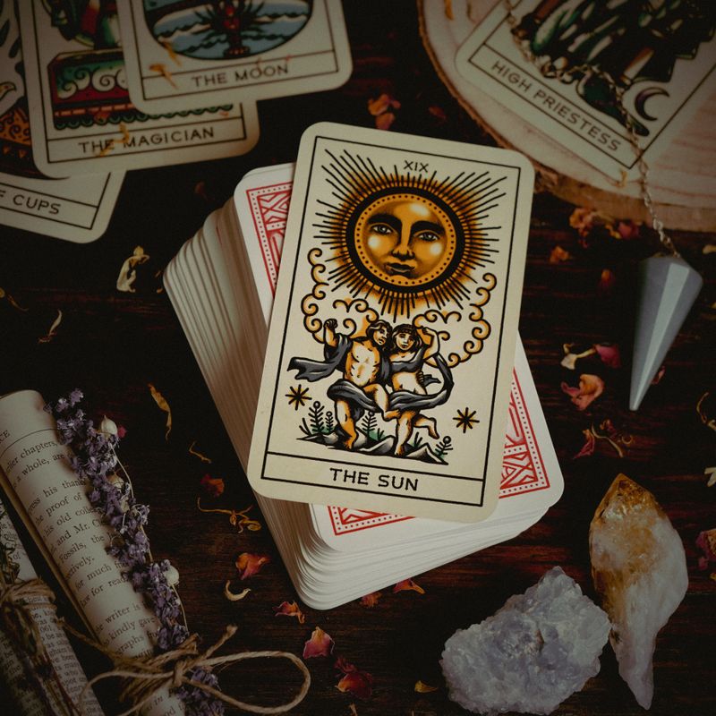 Tarot cards and crystals laid out for a single-card reading