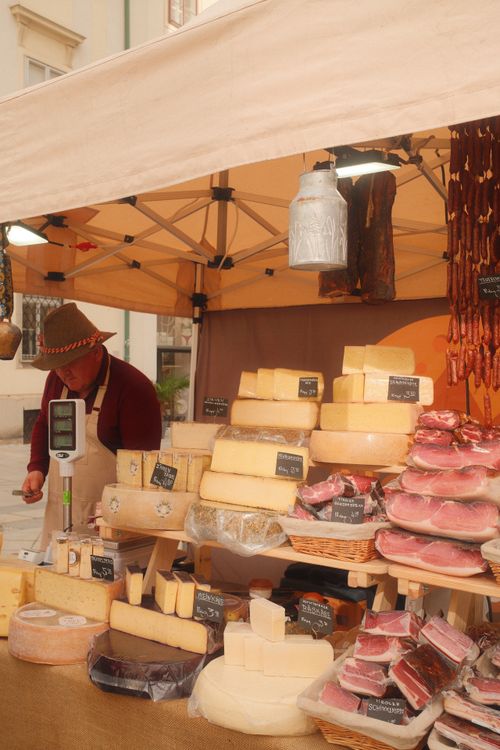 Free Market stall with cheese and meats in Vienna's outdoor market. Stock Photo
