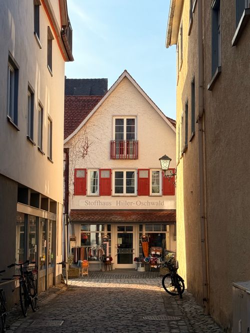 Free Cozy European street scene showcasing a quaint boutique with bicycles outside. Ideal for travel inspirations. Stock Photo