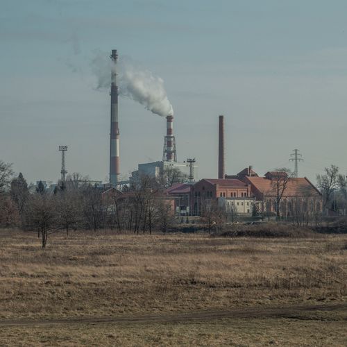 Free Industrial plant with smokestacks in Wrocław, Poland, under a clear sky. Stock Photo