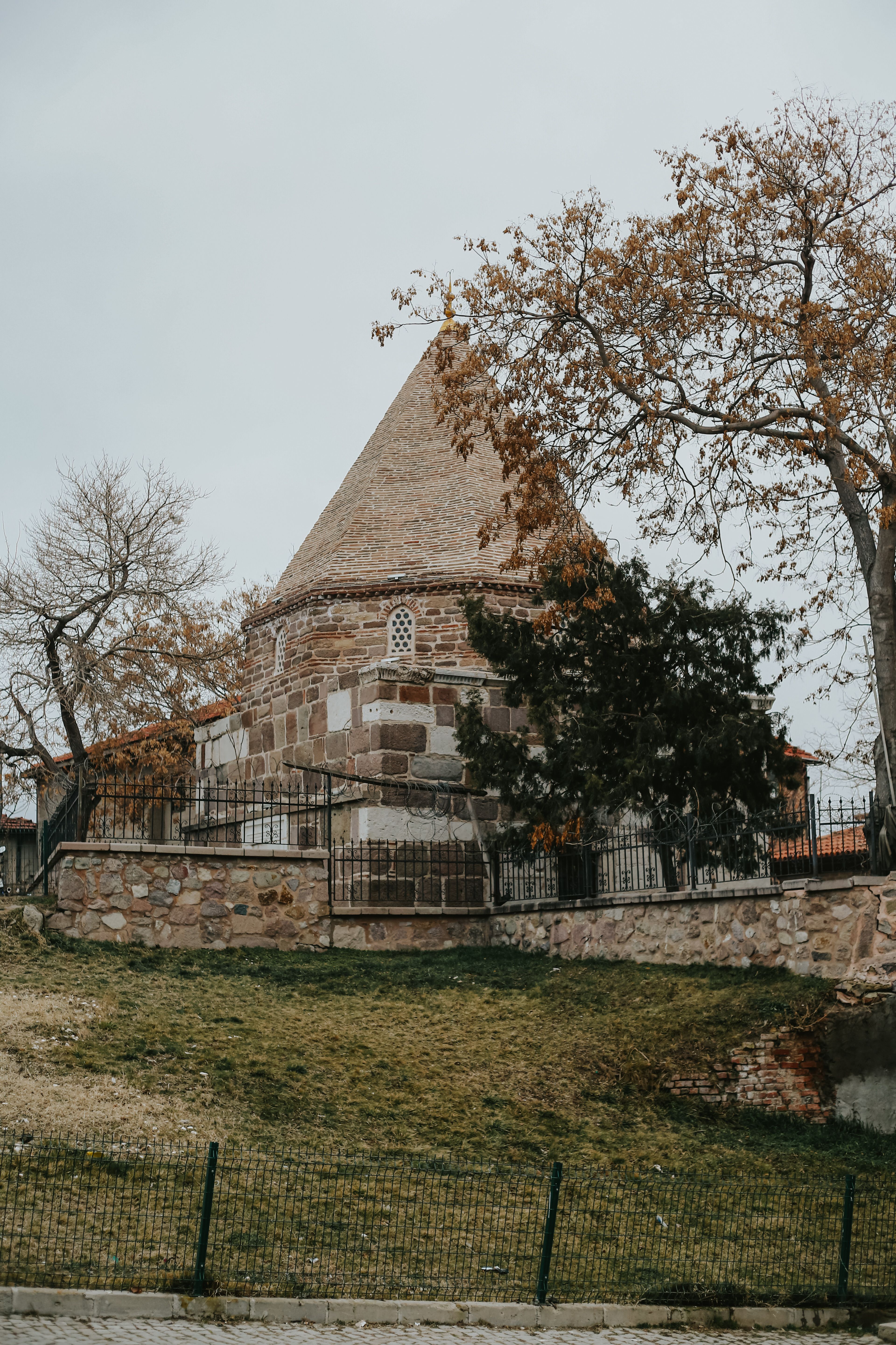 Ancient Stone Building with Conical Roof in Autumn · Free Stock Photo
