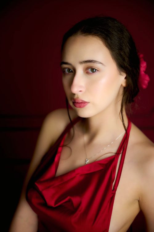 Free Stunning portrait of a woman in a red dress with a captivating gaze. Stock Photo