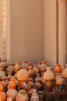 Display of handmade clay pots in Nizwa's market showcasing traditional Omani pottery.