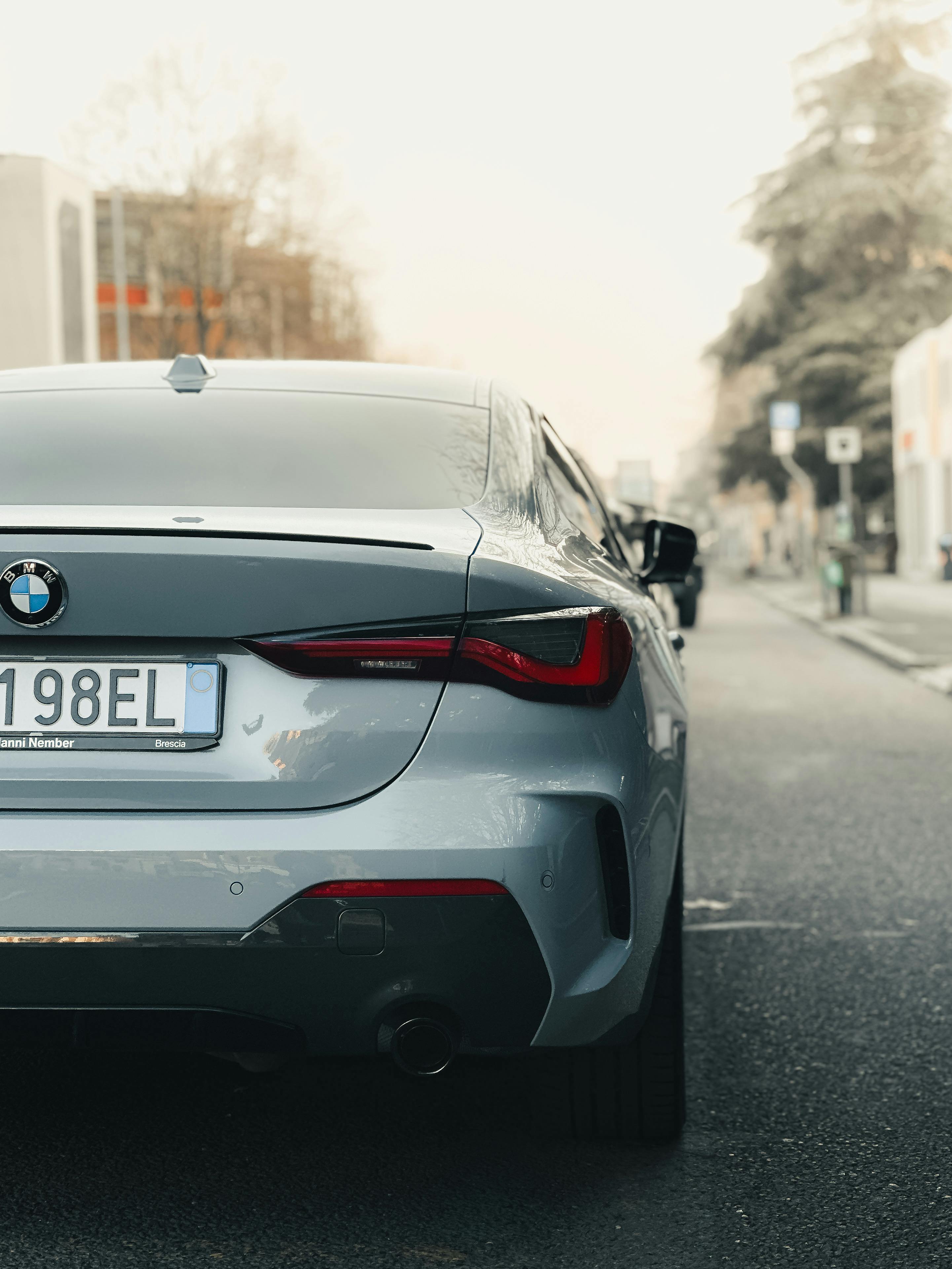 Free Luxury silver car parked on a city street during the day, showcasing urban elegance. Stock Photo