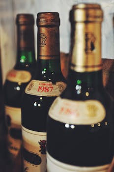 Close-up of vintage wine bottles showcasing rustic charm and nostalgia. Perfect for vintage collections.