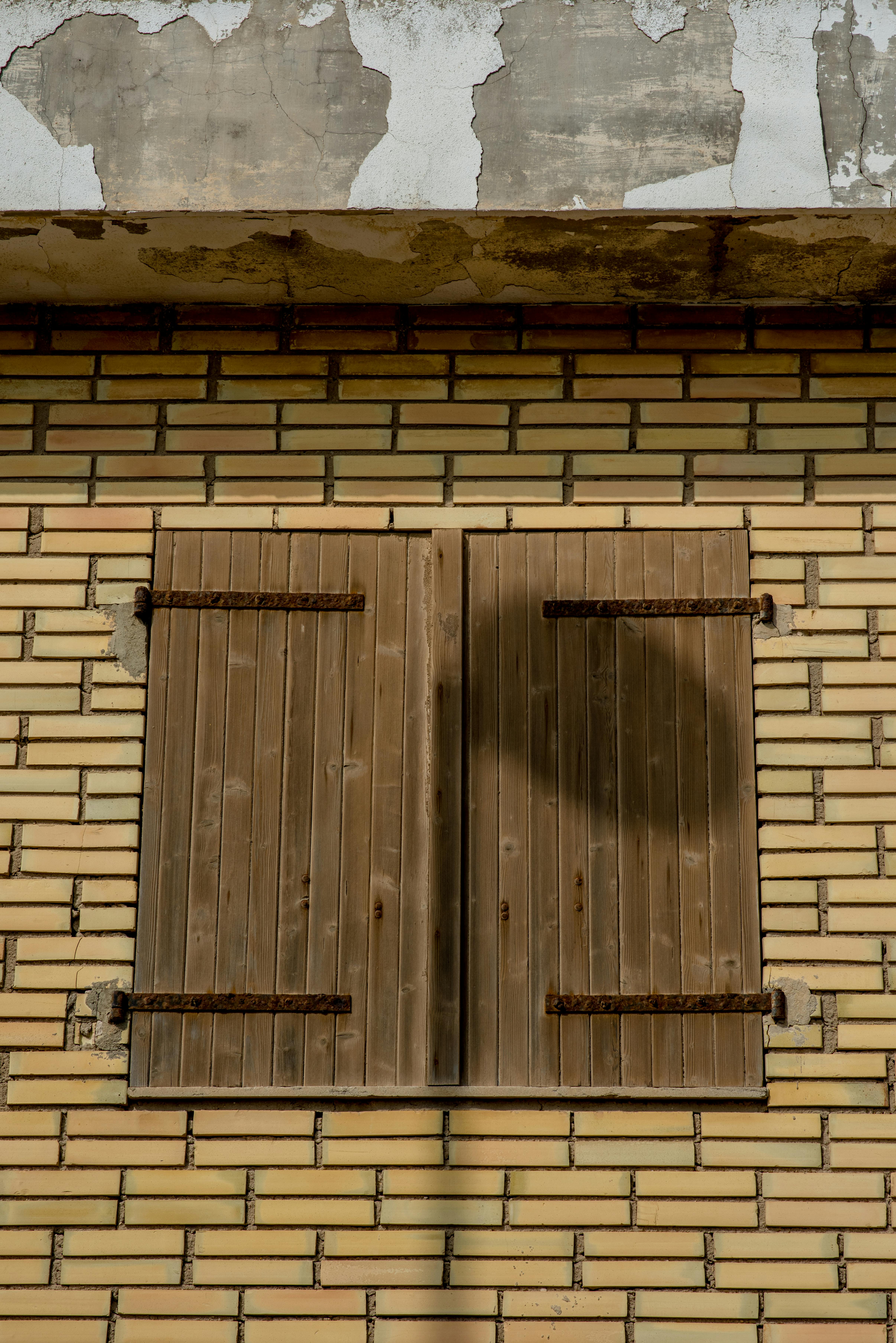 wooden shutters on vintage brick wall