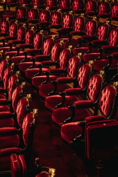 Elegant plush red velvet seats in an opulent opera house setting, exuding classic luxury.