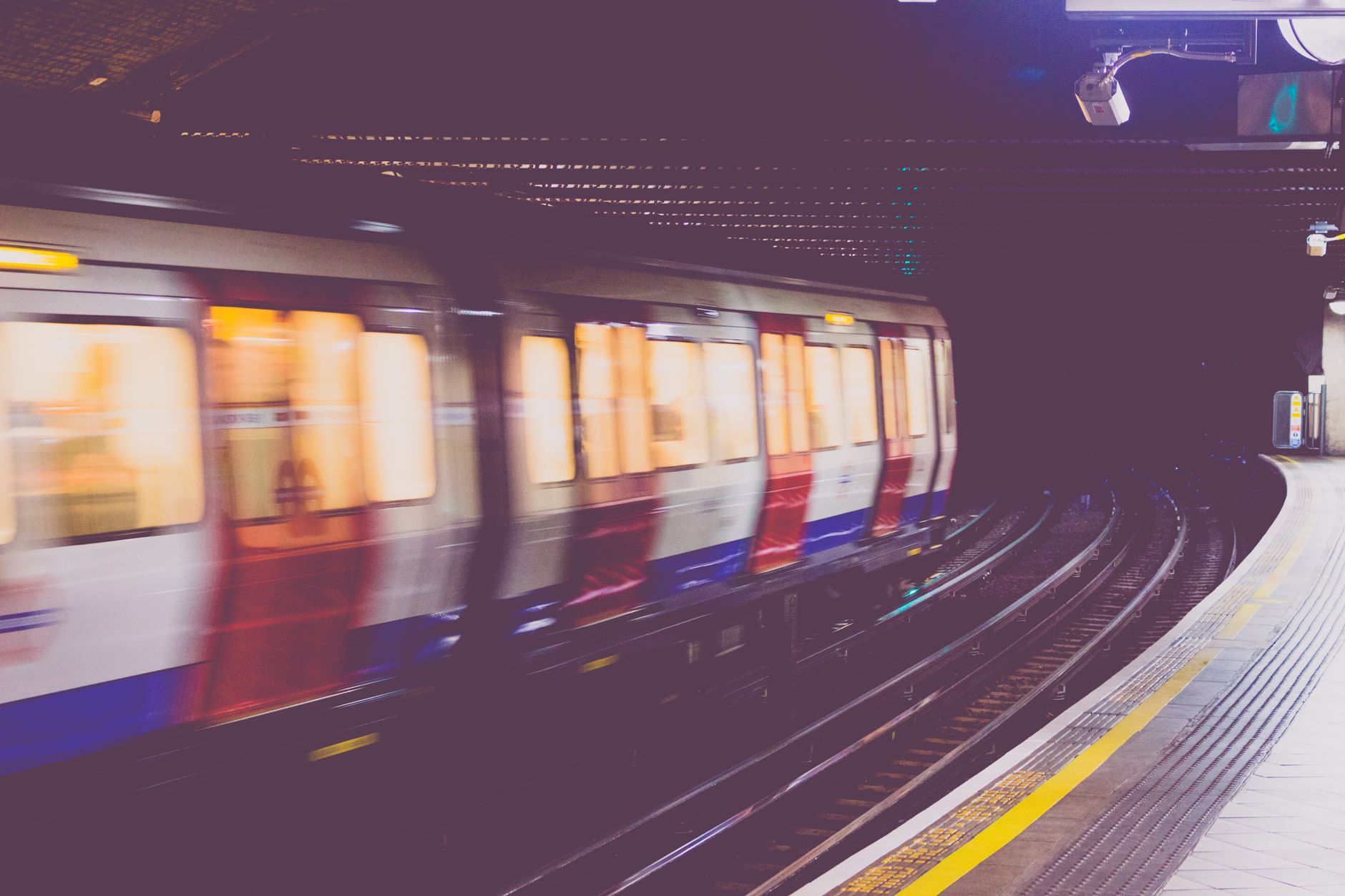 A moving train captured at high speed inside an urban tunnel, conveying motion and modern transportation.