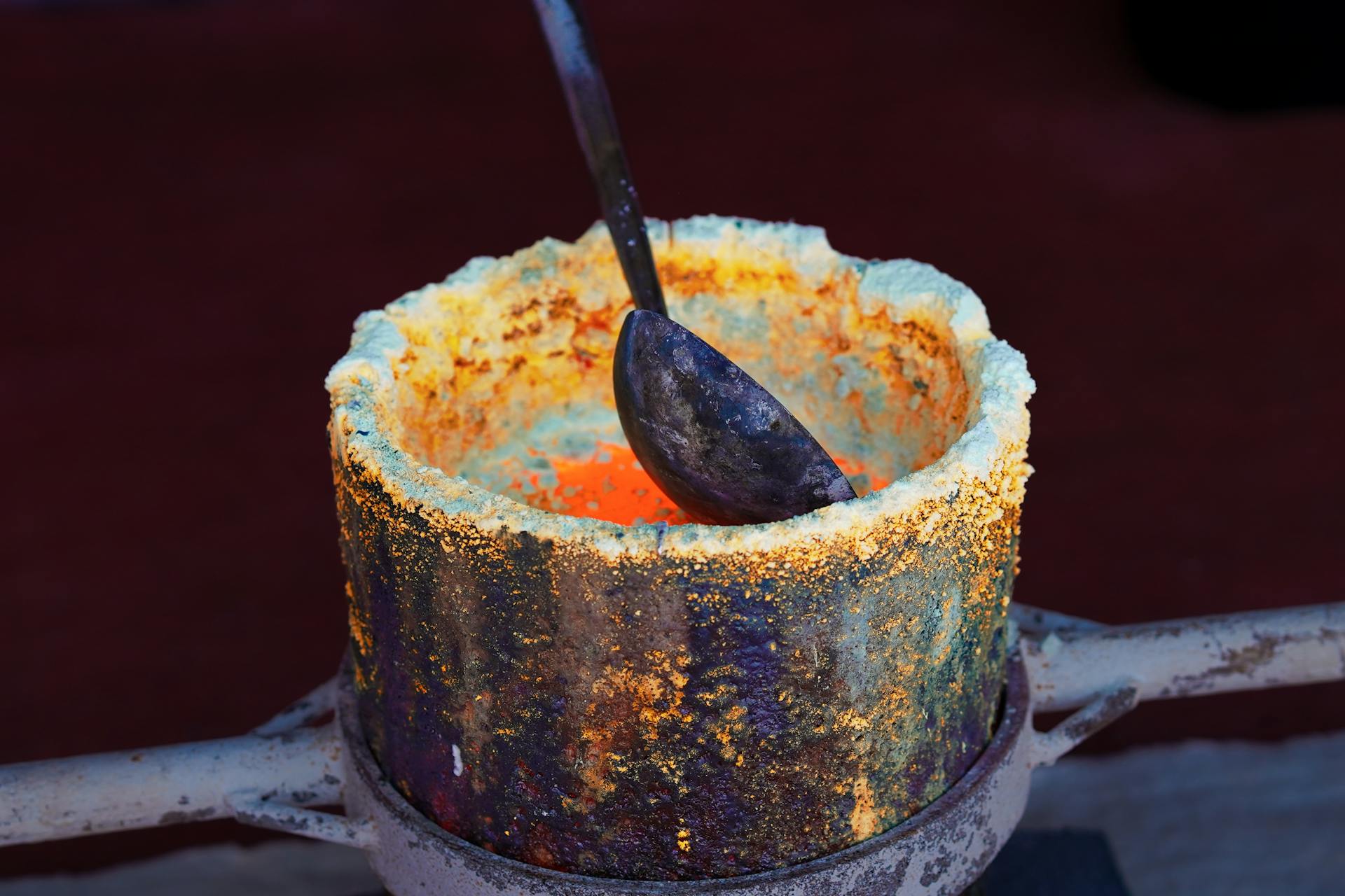 Close-up of molten gold in a crucible, showcasing the smelting process at a Bangkok foundry.