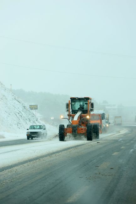 snow plow clearing road winter