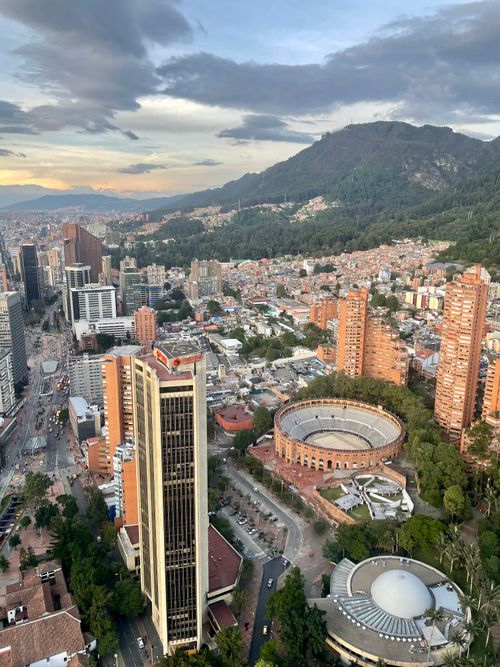 Free Aerial view of Bogotá featuring Torre Colpatria and the iconic bullring at sunset. Stock Photo