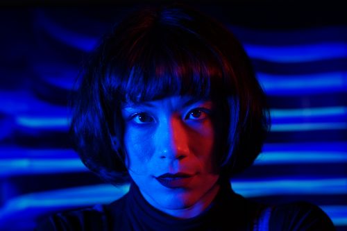 Free Intense portrait of a person with striking blue and red lighting effects. Stock Photo