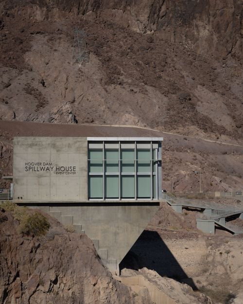 Free The Hoover Dam Spillway House stands against rugged Nevada terrain under clear skies. Stock Photo