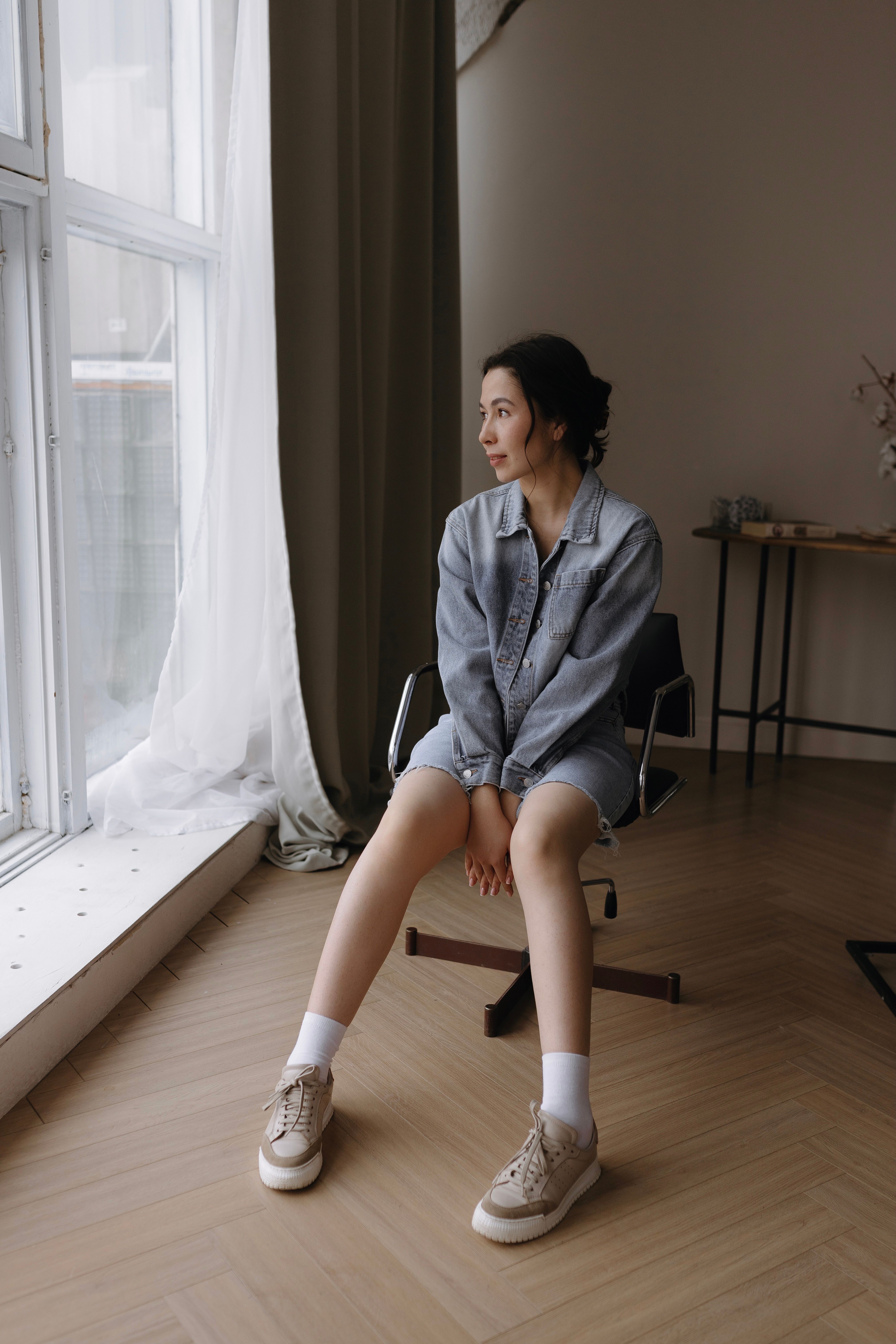 Young Woman Sitting in a Stylish Indoor Setting · Free Stock Photo