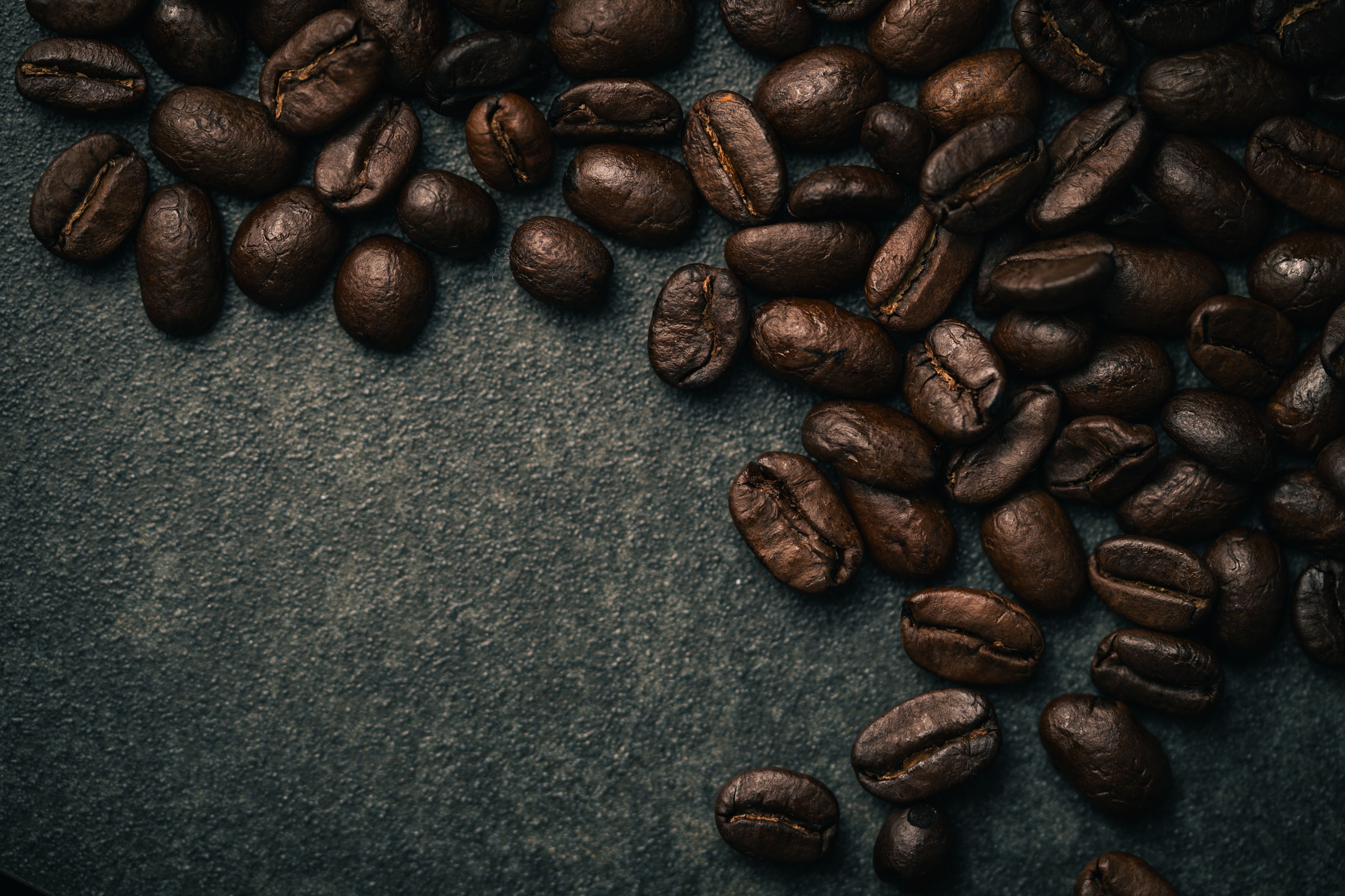 Close-up of Roasted Coffee Beans on Dark Background · Free Stock Photo