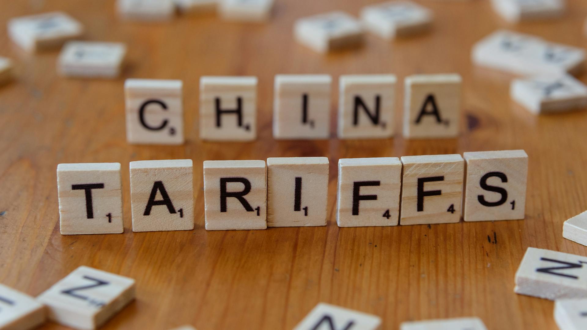 Scrabble tiles spelling 'China' and 'Tariffs' symbolize global trade issues.