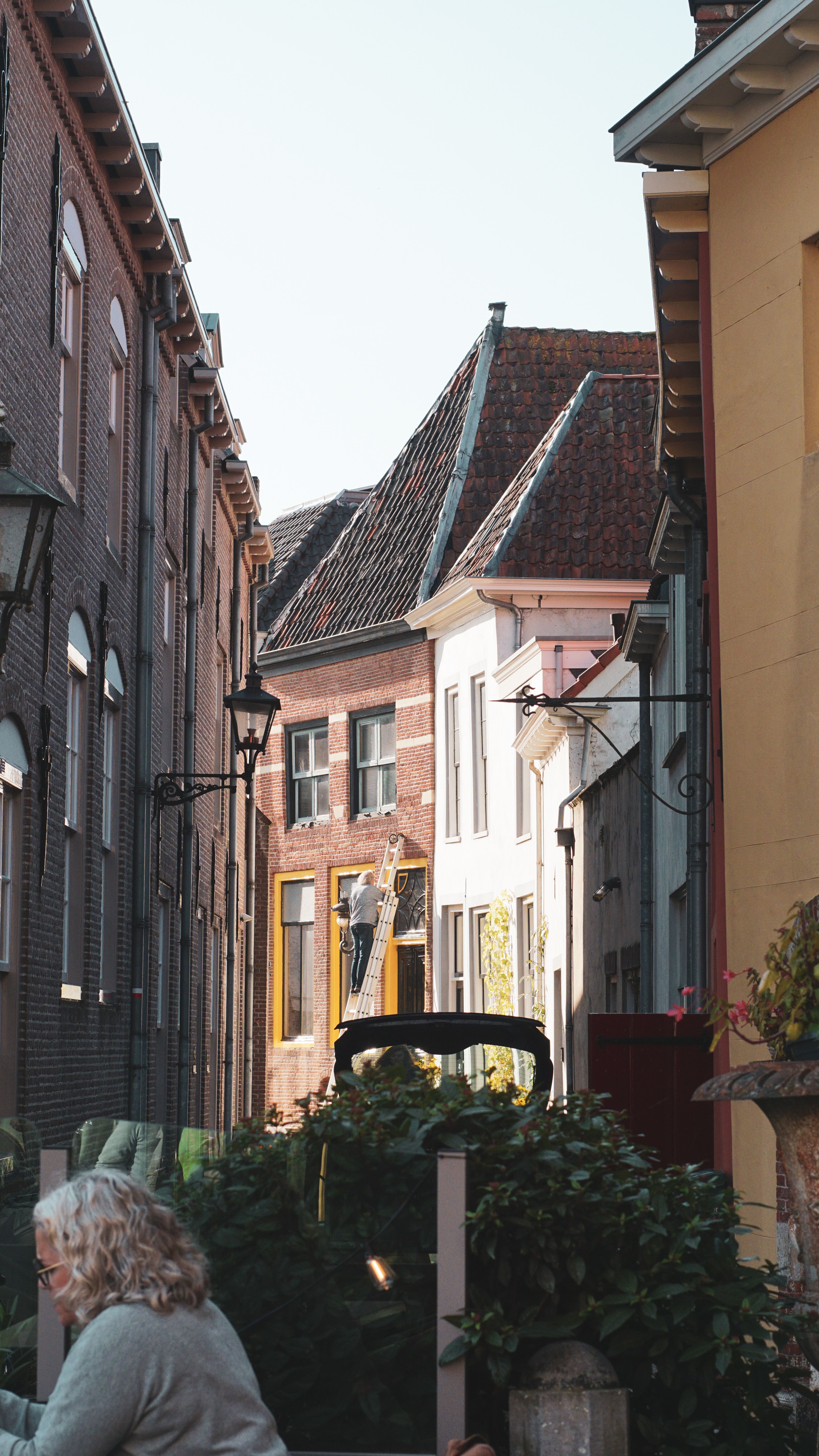 A picturesque street view of historic European buildings with a cozy outdoor cafe.