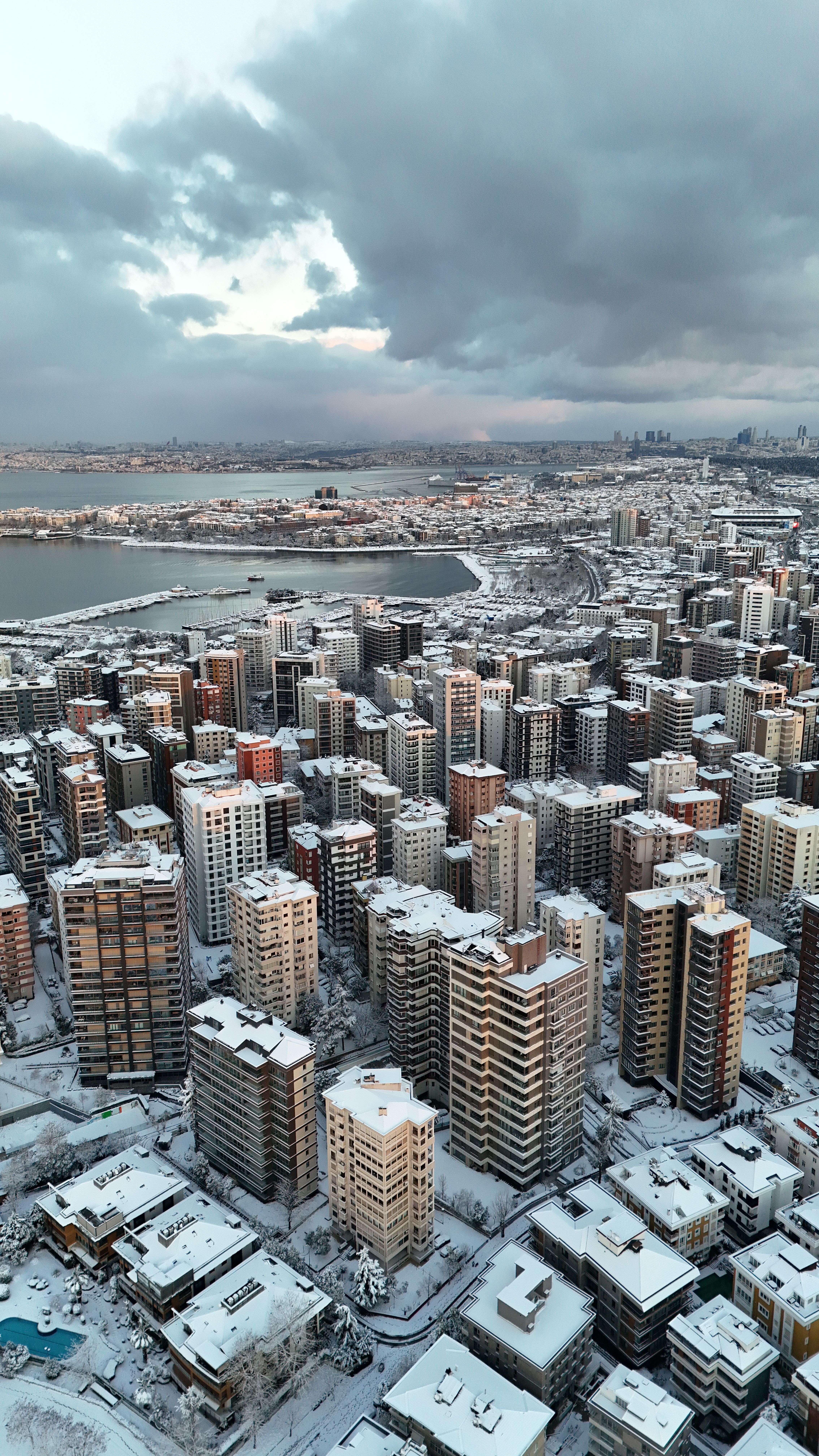 Stunning aerial shot of Istanbul covered in snow, showcasing urban cityscape and snowy skyline.