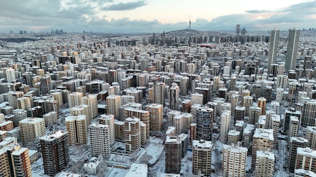 A captivating aerial shot of Istanbul covered in snow, showcasing urban density and iconic skyline.