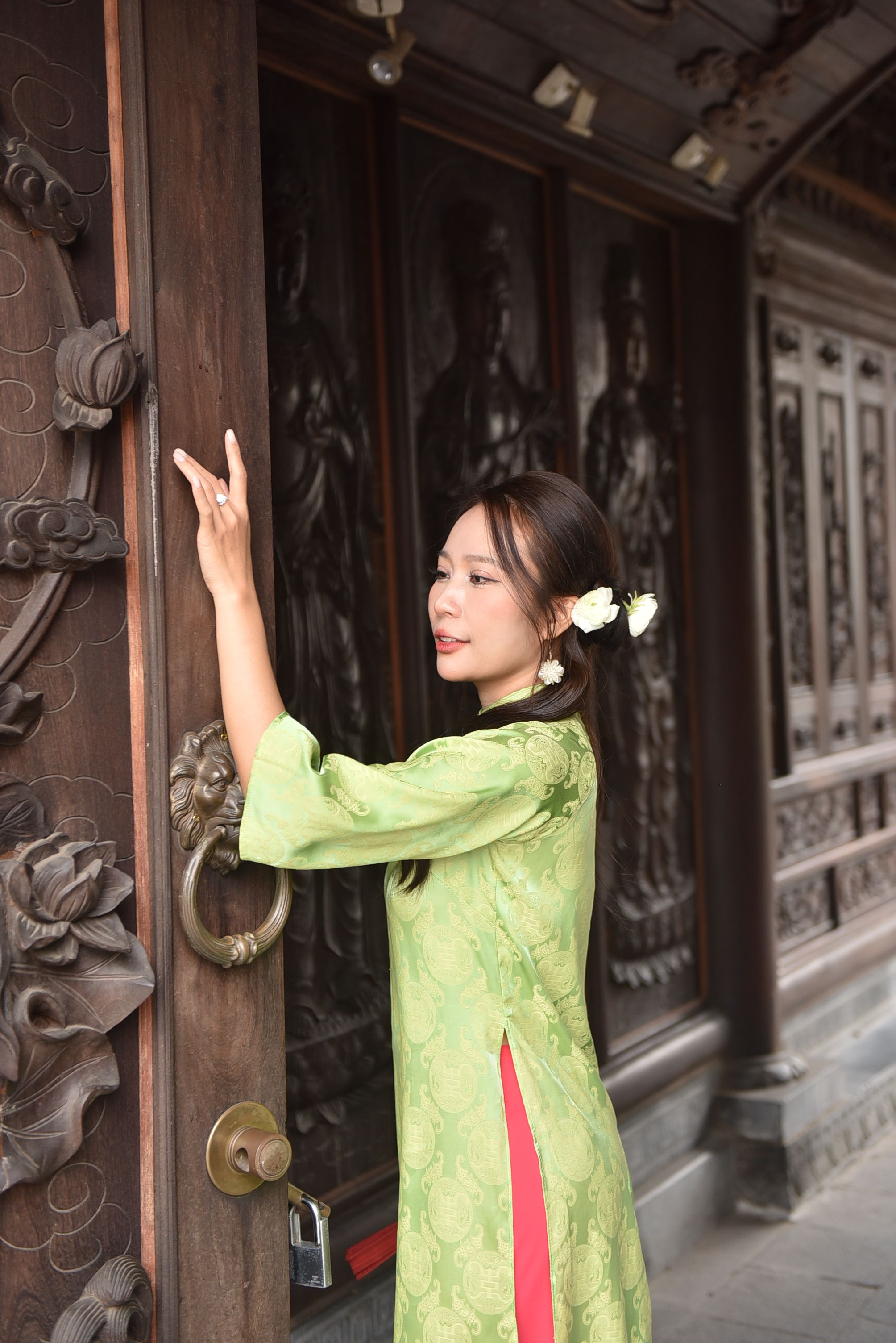 Woman in Traditional Green Dress at Ornate Doorway · Free Stock Photo