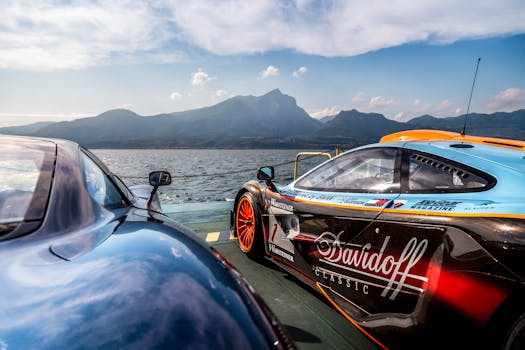 Supercars by a lake with a mountain backdrop, highlighting speed and luxury.