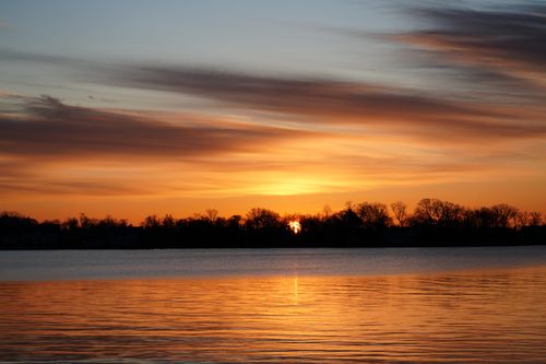 Free Serene sunrise over Cove Island Park, Stamford with a vibrant pink sky and calm waters. Stock Photo