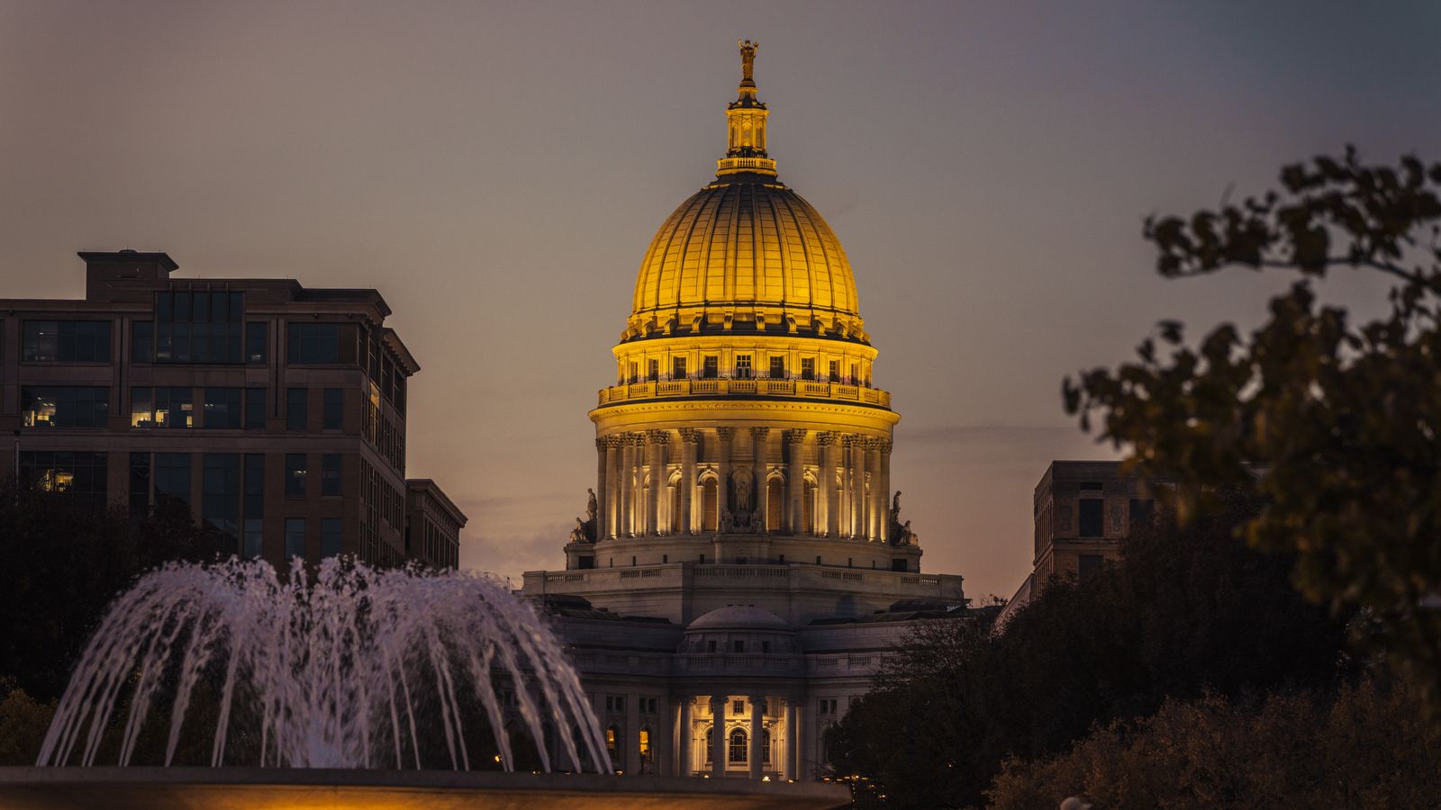 The Wisconsin State Capitol illuminated during twilight, showcasing its architectural beauty.