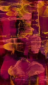 A colorful abstract painting with expressive brushstrokes in red, pink, and yellow.