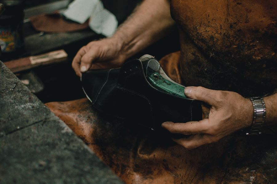 A sole being shaped by hand