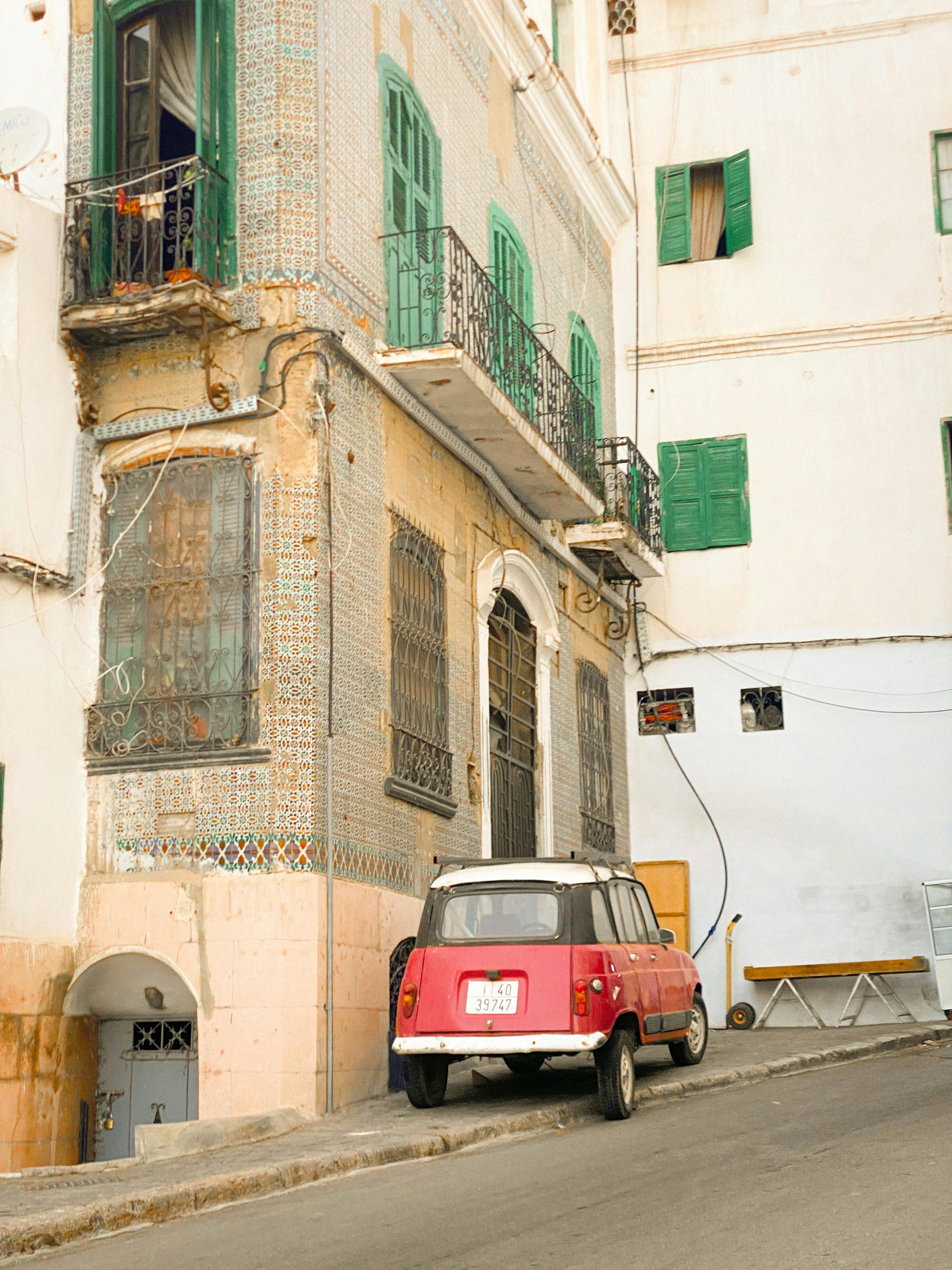 vintage car parked by historic moroccan building