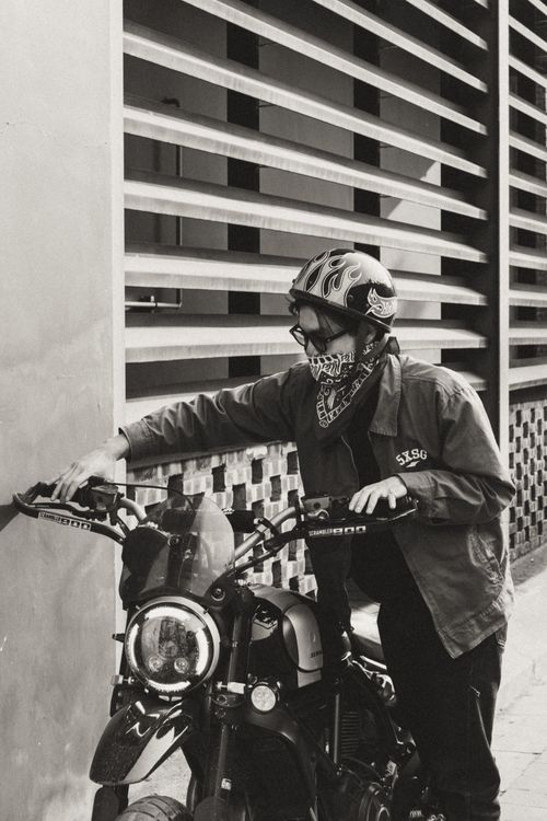 Free Black and white photo of a biker with helmet by a motorcycle in Việt Nam. Stock Photo