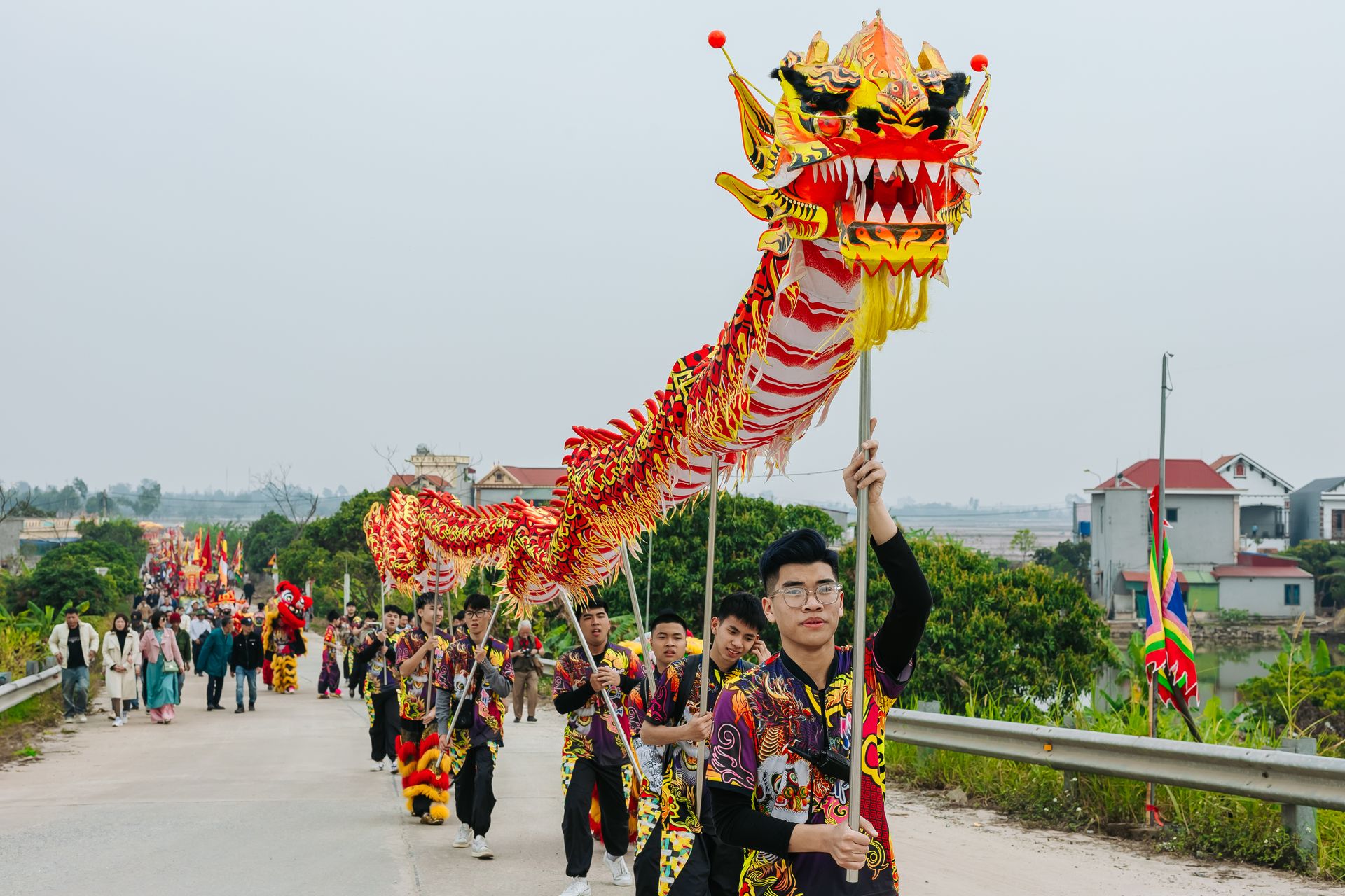 Lively outdoor dragon dance parade celebrating Asian culture with colorful costumes and joyful participants.