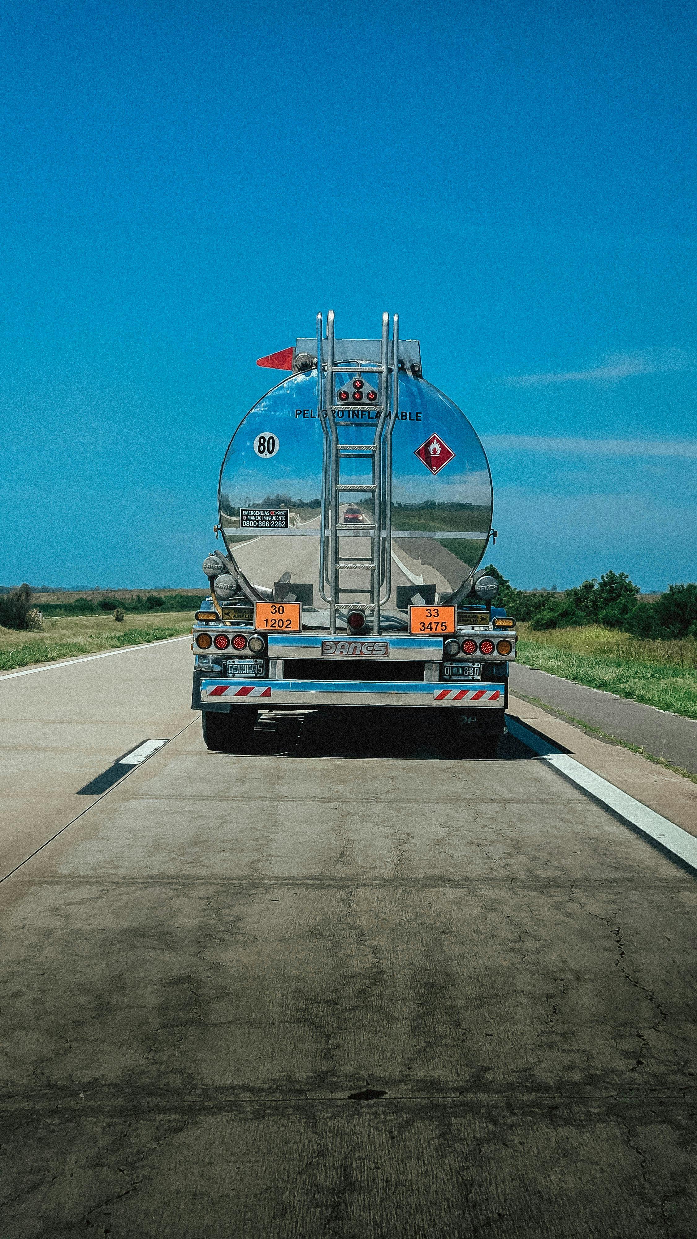 Free A fuel tanker truck travels along a highway under clear blue skies in Argentina. Stock Photo