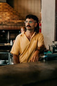 A stylish person in a cafe exudes a retro vibe with a modern twist.