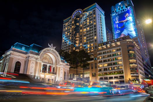 Dynamic night view in Ho Chi Minh City featuring the iconic Opera House and bustling city lights.